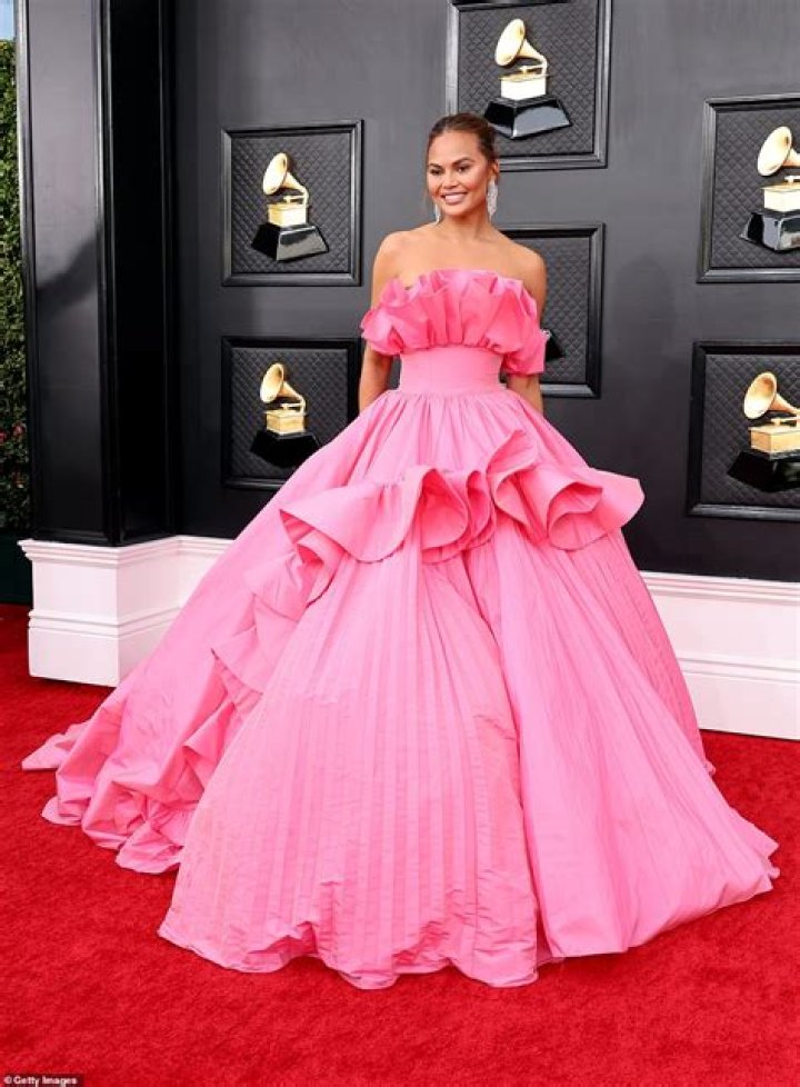 Chrissy Teigen Turns Heads In Bright Pink Strapless Gown At 2022 Grammy Awards: Photos